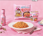 a plate of noodles and a bottle of sauce